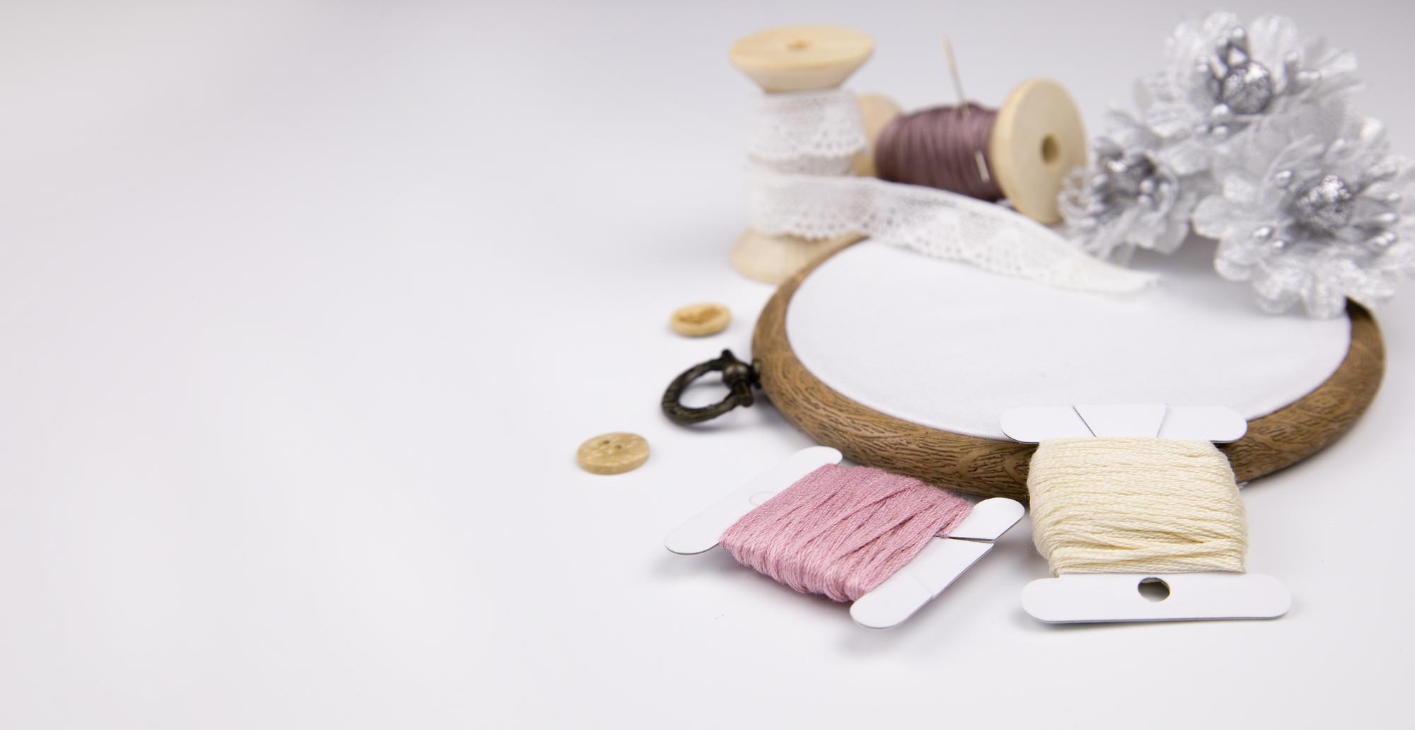Workshop hands arranging modern embroidery threads