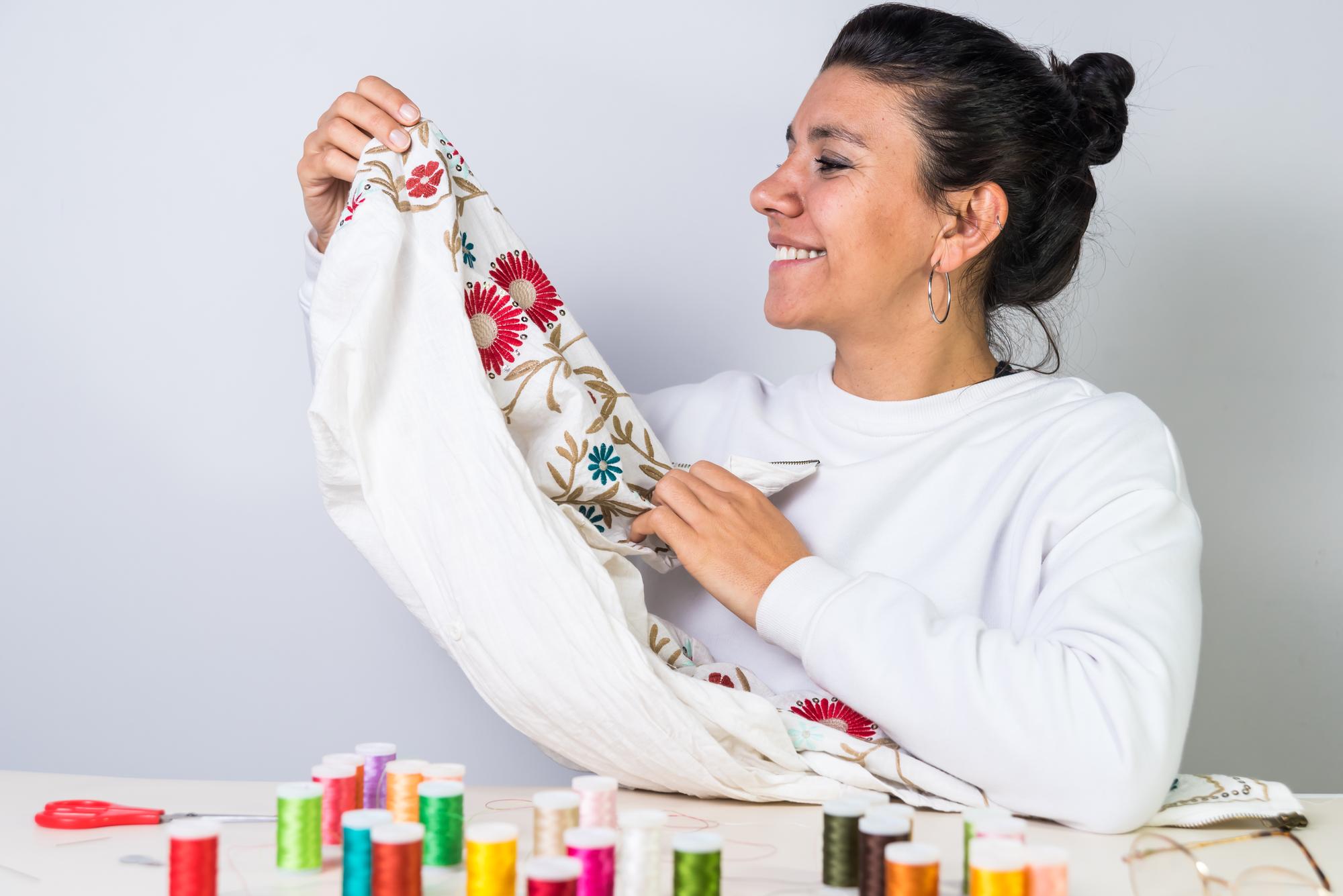 Anna, lead embroiderer, arranging threads